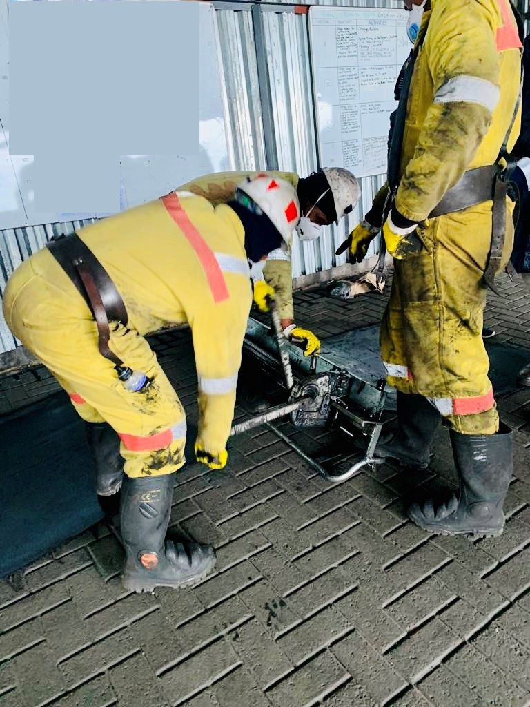 Belt crew servicing conveyor idler rollers